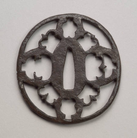 Round Sukashi iron tsuba from the Akasaka School.  Kiku form, pierced birds in flight.