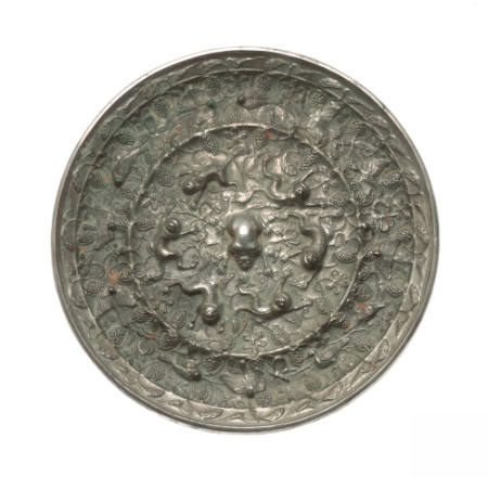 Mirror decorated with lions, doves, cranes, butterflies and grapevine clusters