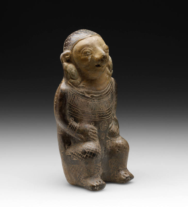Seated male effigy whistle