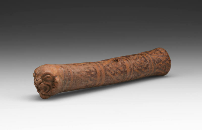 Flute with snarling feline face