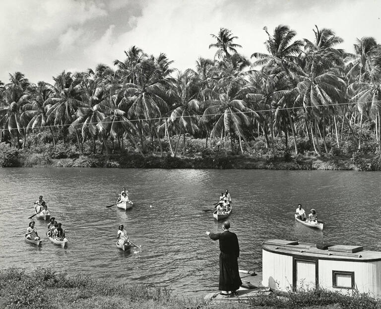 [Father Gregory Sontag helps parishoners to dock at Sittee River Mission]