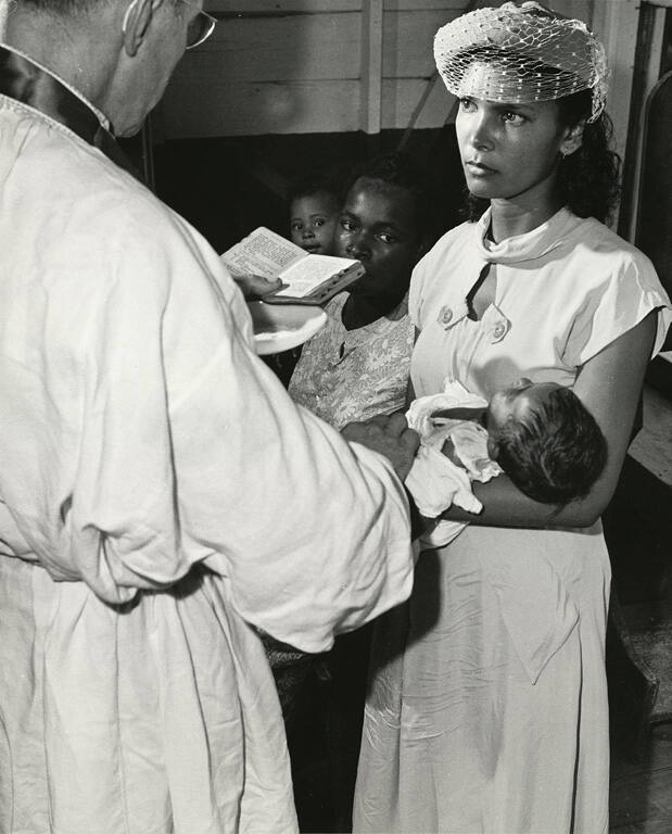 [Father Sontag administers the sacrament of Baptism]