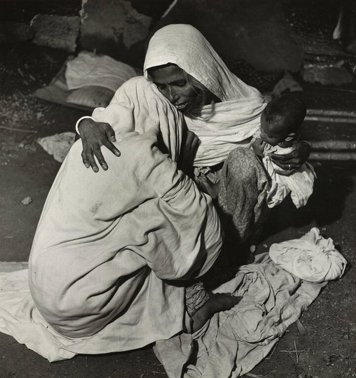 [Indian woman consoling a mourner]