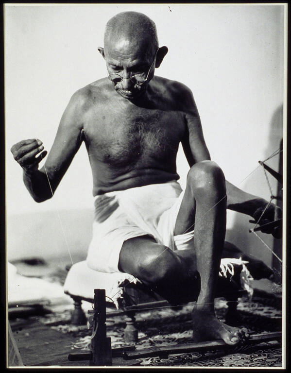 [Mohandas Gandhi at his spinning wheel, Poona, India]