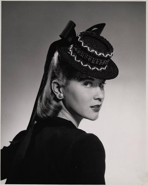 [Fashion photograph of woman wearing hat]
