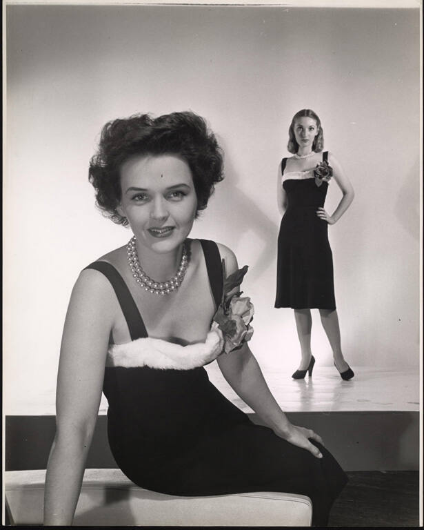[Fashion photograph of two women each wearing dress with fur trim]