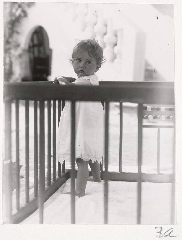 [Baby standing in crib]