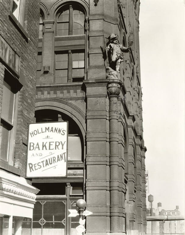 [Puck statue on building]