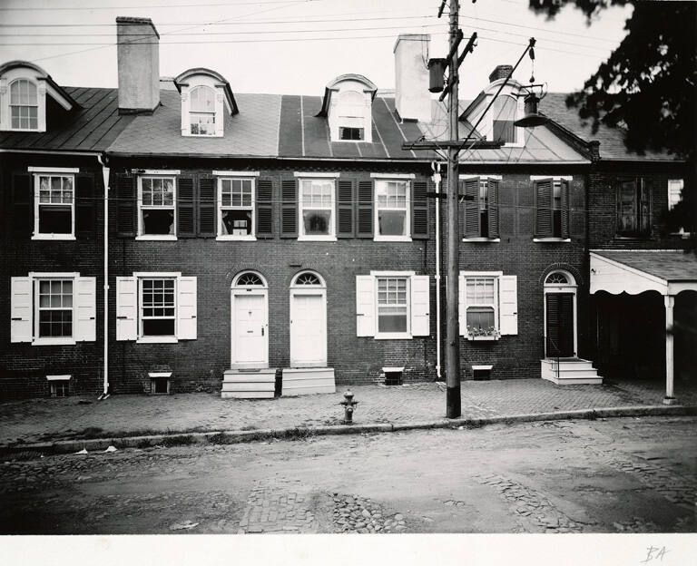 [Brick rowhouses with wooden steps]