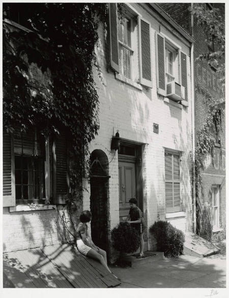 [Two girls in front of house]