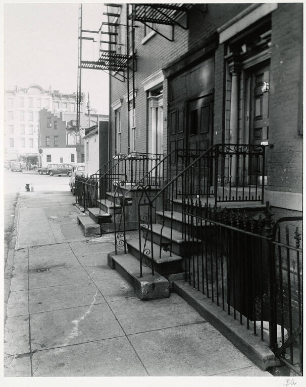 [Rowhouse with ornamental iron rails]
