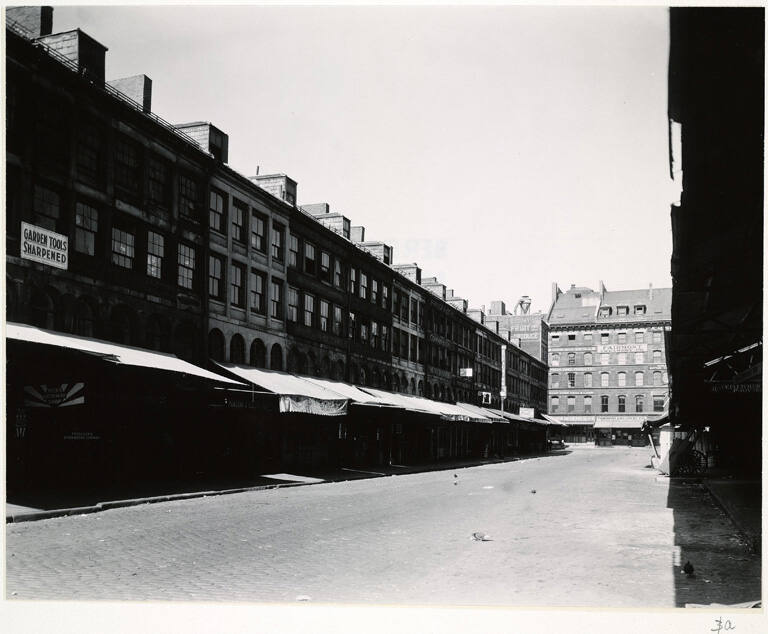 [Street view of stores with awnings]