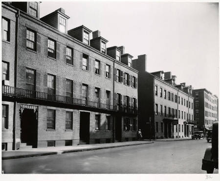[Street with brick rowhouses]