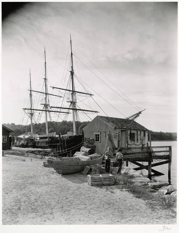 [Children, lobster traps, and ship on coast]