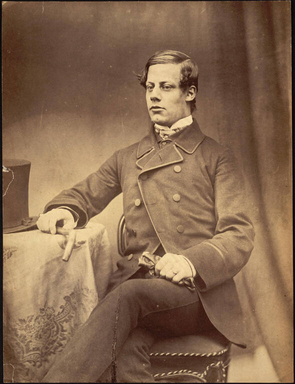 [Seated man holding gloves]