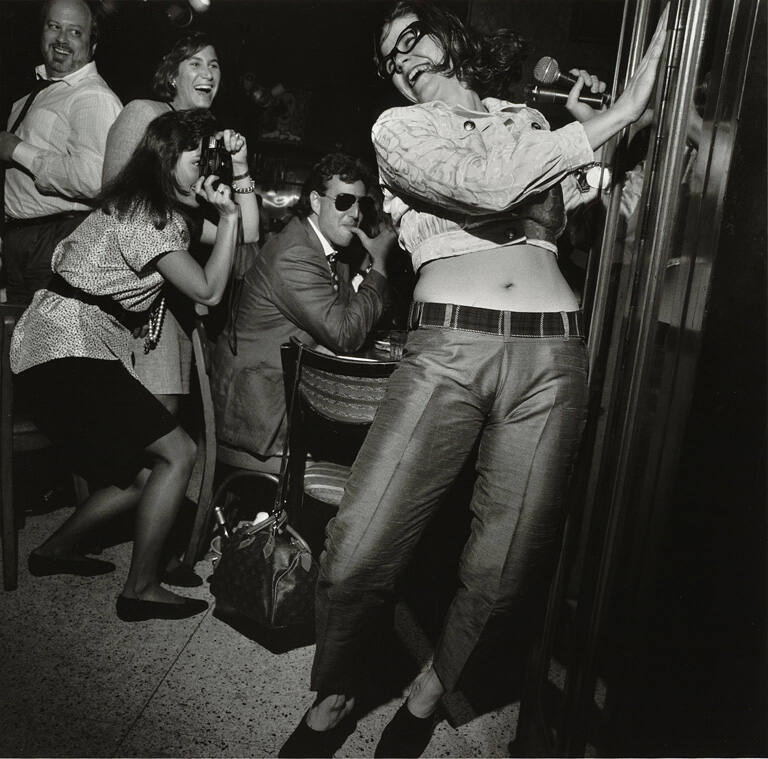 Trixies, NYC—Woman dancing for small crowd, May 1990, from the portfolio Social Context