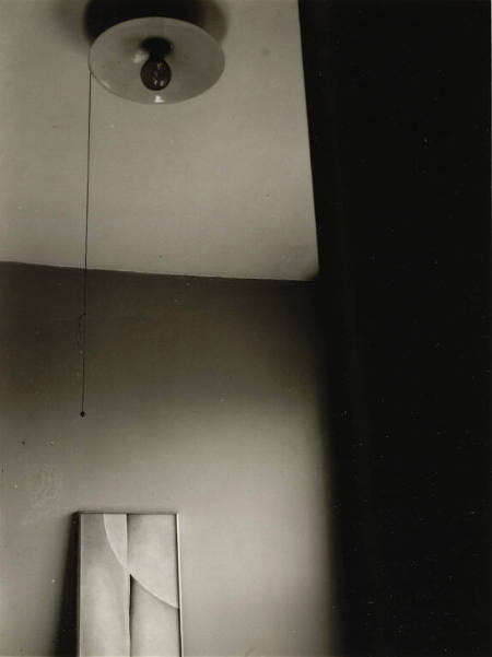Georgia O'Keeffe painting with light bulb, from the portfolio Dorothy Norman: Selected Photographs