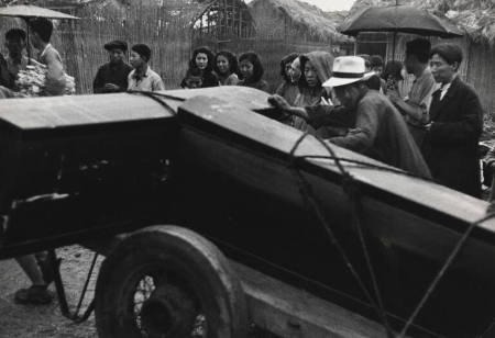 Coffins of recent air raid victims of a Nationalist bombing raid aimed at Shanghai are wheeled through the affected village