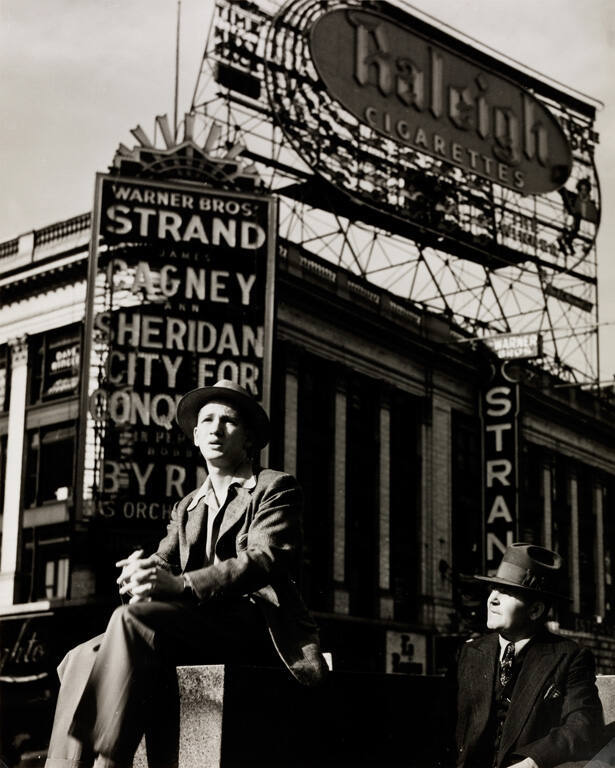 Sitting in front of the Strand Theater, Times Square, New York
