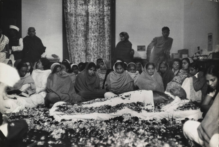 Gandhi's body surrounded by flowers and seated women, New Delhi, India