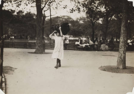 [Woman carrying a large bundle]