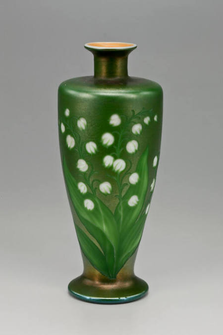 Green vase with lilies of the valley