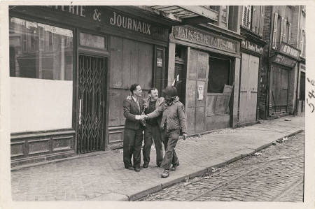 [Cheering Frenchmen stopping American soldier to shake his hand]