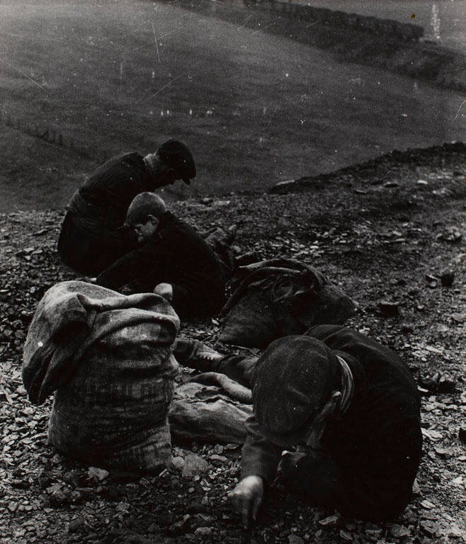 A group of coal searchers near Heworth, Tyneside; pithead train in the distance
