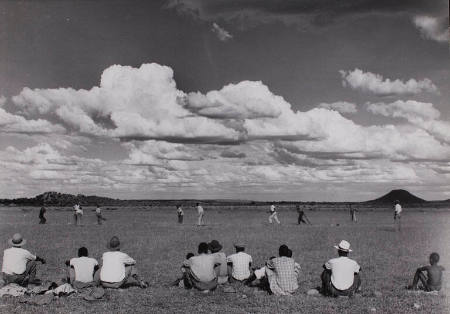 [Members of the Bamangwato tribe watch as other play cricket, Serowe, Botswana]
