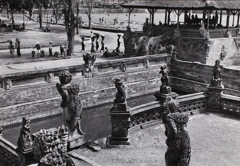Decorative temple statues and pedestrians, Indonesia