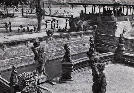 Decorative temple statues and pedestrians, Indonesia