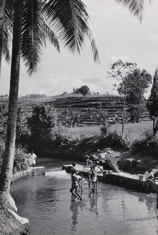 People bathing and washing clothes in river, Bali