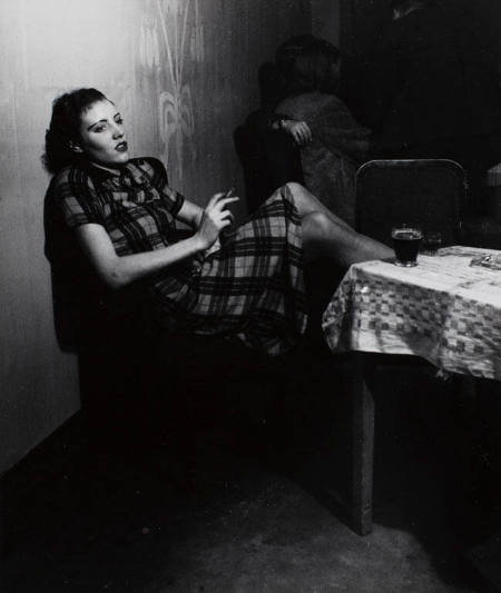 [Girl smoking, leaning backward in a chair]