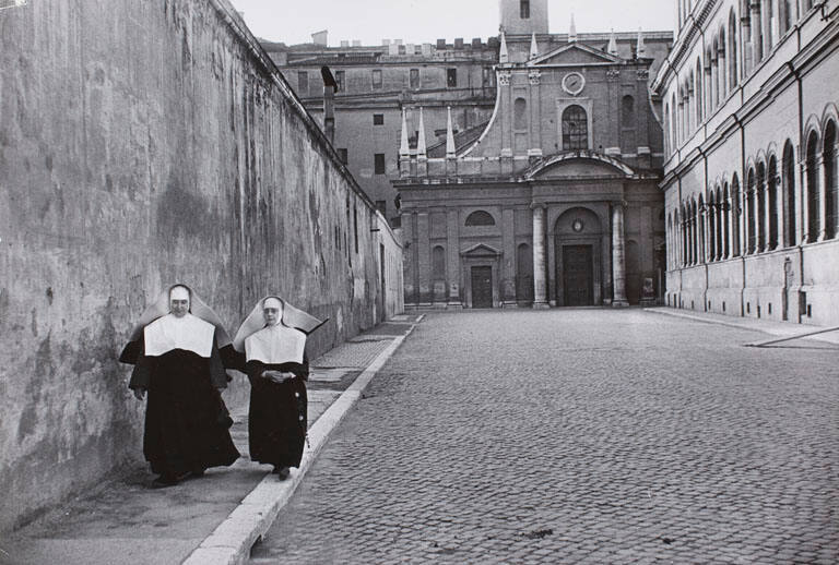 Two nuns walking down an empty street, Rome