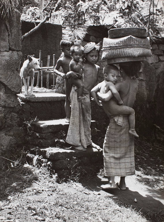 Two little girls carrying their little brothers, Ubud, Bali