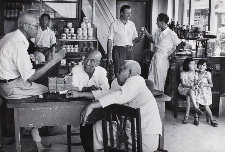 Men talking in Chinese store, Indonesia