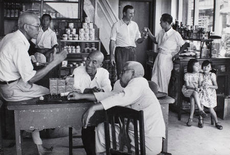 Men talking in Chinese store, Indonesia