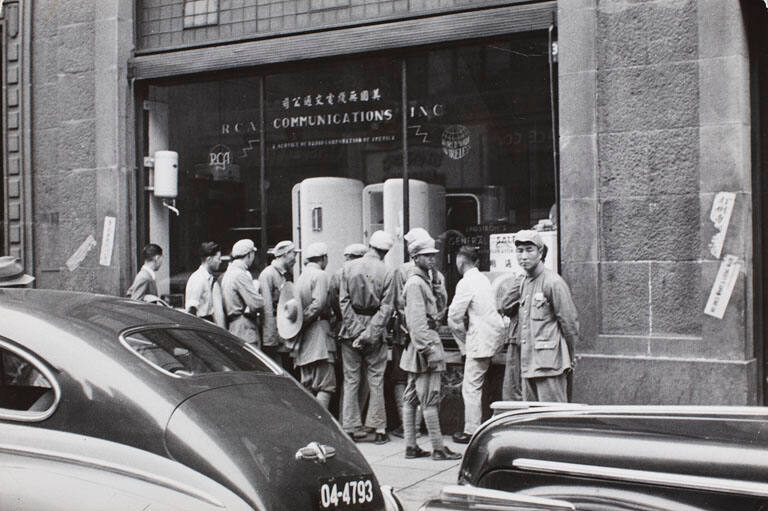 Country soldiers intrigued by a shop display of refrigerators, a non-Communist luxury, during their first visit to Shanghai