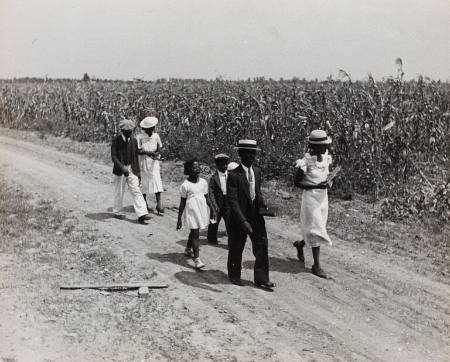 Sharecropper Lonnie Fair and his family walking to Sunday school and church, Mississippi