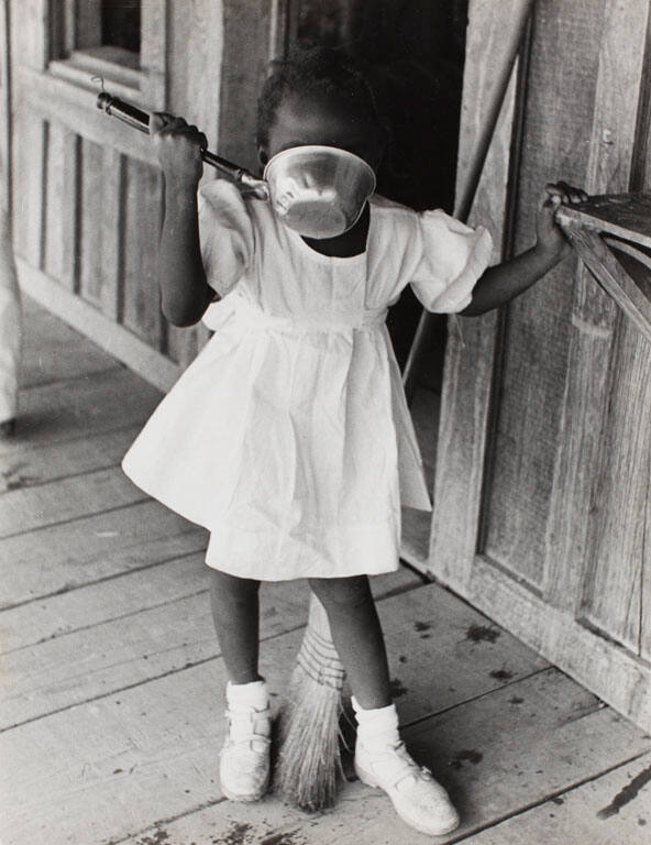 Sharecropper Lonnie Fair's daughter drinking water before going to church