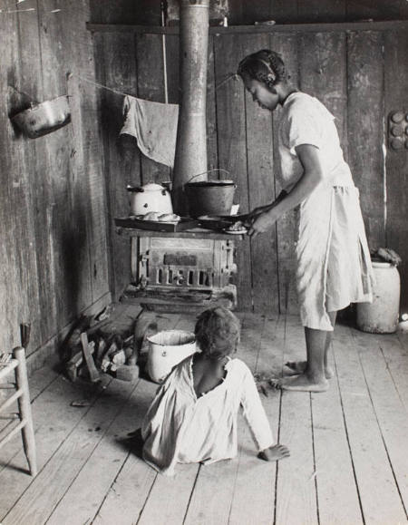 Wife of sharecropper, Lonnie Fair, cooking at home