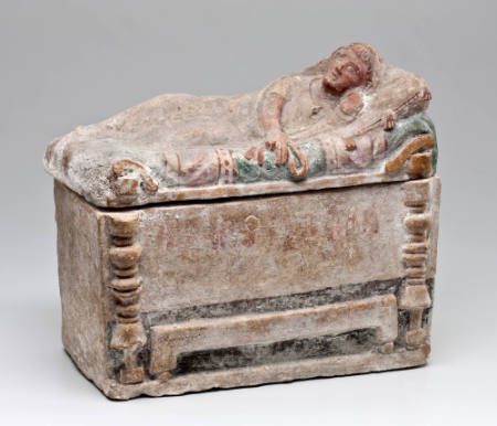 Cinerary urn in the shape of a sarcophagus with reclining man on lid