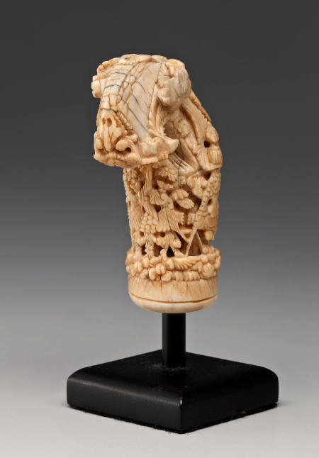 Kris handle; ivory to light brown color, with intricate foliate carving