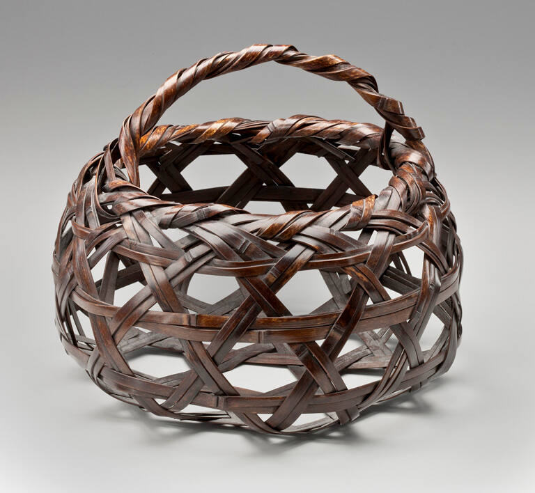 Basket of roughly spherical form, with large openings in the weave