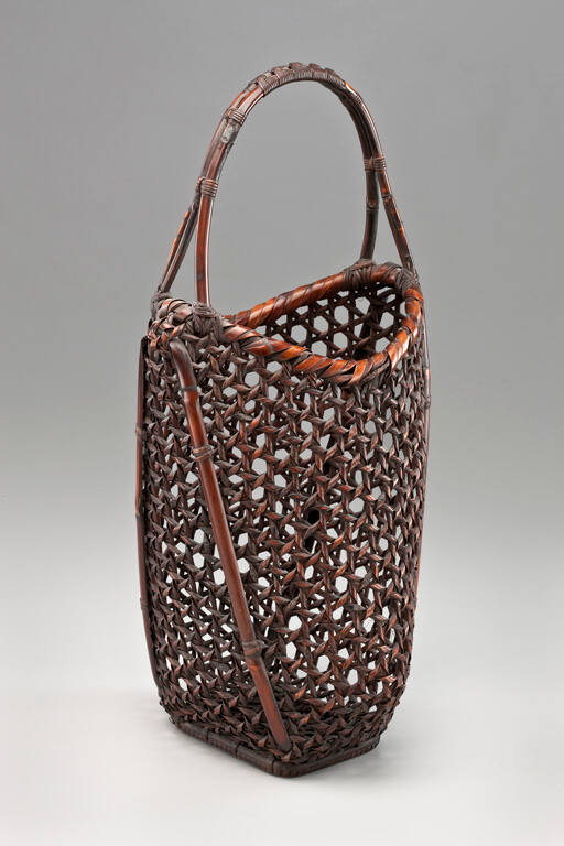 Open-weave basket of broadening form, having a single, arced handle