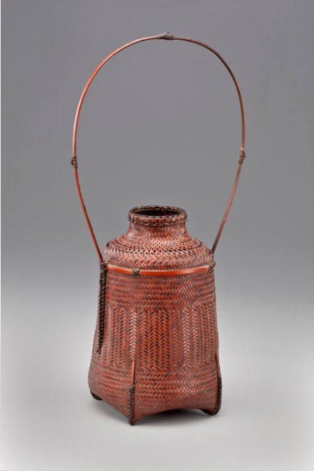 Precisely woven basket with long, looped handle