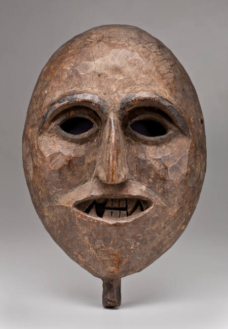 Mask of human face, mouth open, jagged teeth exposed