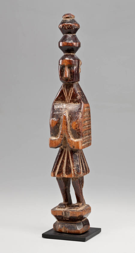 Standing wooden figure with "praying" hands