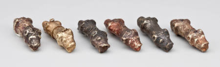 Six hollow beads in the form of two addorsed feline heads, plus one fragmentary head of another feline