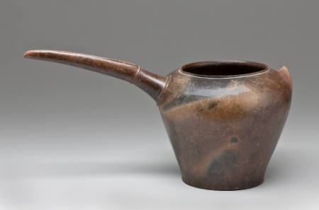Brown-colored vessel with beak spout